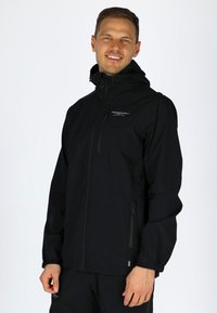 Black waterproof jacket with a zip front, adjustable hood, elastic cuffs, and side pockets. Features a small logo on the chest.
