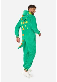 Felpazza verde a tema dinosauro realizzata in un morbido e testurizzato pile. Presenta un cappuccio attaccato, macchie arancioni e gialle, e una coda.