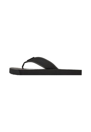 Flip-flop negro con suela de goma plana, tira de tela texturizada y un diseño minimalista sin patrones ni acentos visibles.