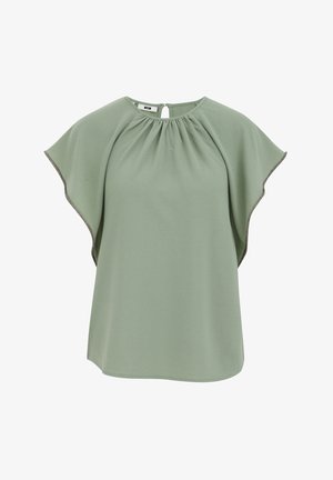 Zelena bluza s kratkim lepršavim rukavima, naboranim prednjim dijelom i otvorom na leđima s kopčanjem. Mekani teksturirani materijal i kontrastni rubovi duž rubova rukava.