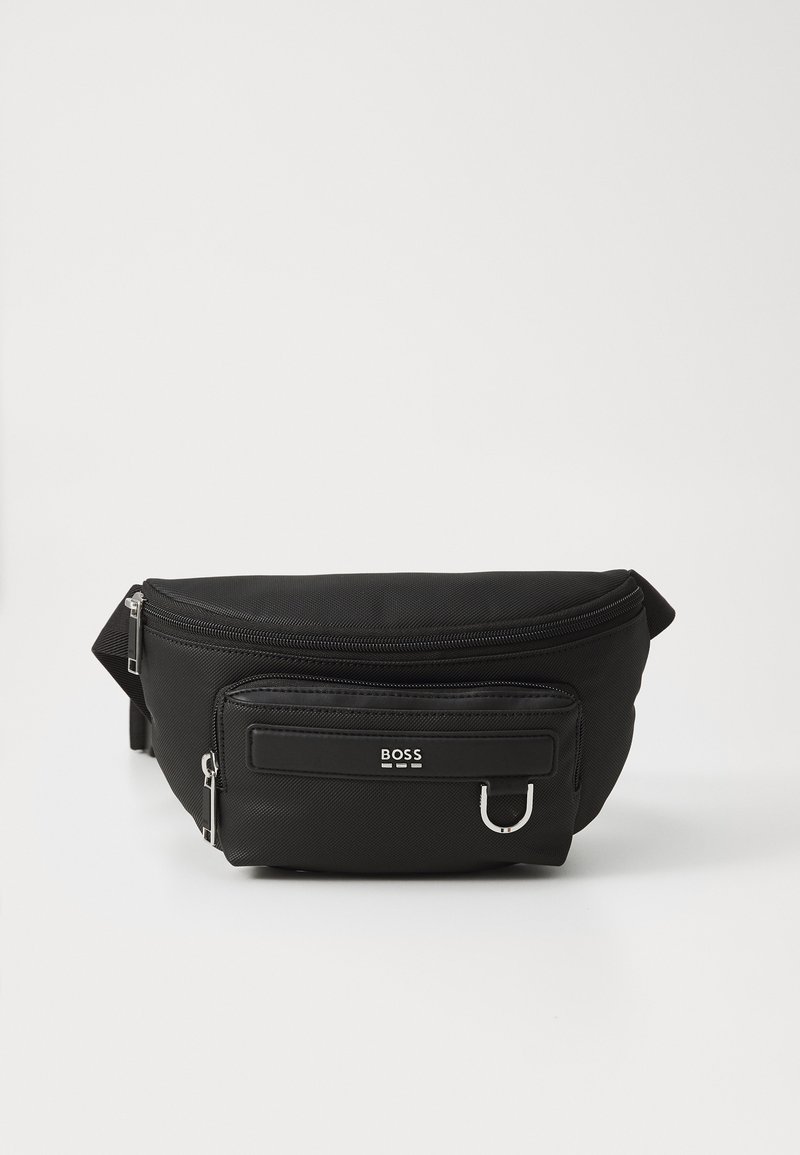 Black nylon fanny pack with a curved design, front zip pocket, and silver hardware accents. Features a logo on the front panel.