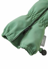 Green waterproof mitten with black zipper and elastic wrist, featuring a "reima TEC" label and adjustable black toggle.