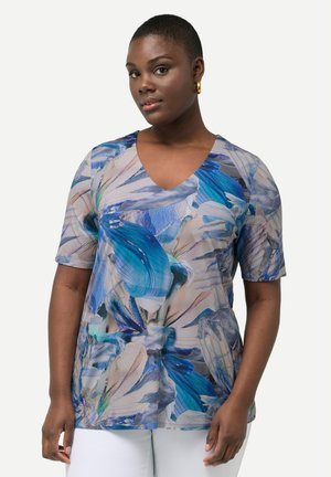 Top a maniche corte con scollo a V in tessuto leggero, caratterizzato da una stampa floreale con tonalità di blu, beige e accenni di bianco; vestibilità rilassata.