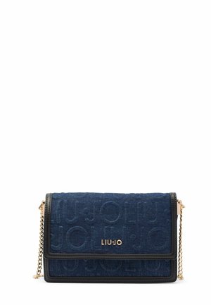 Blue denim crossbody bag with a gold-tone logo, black leather trim, and chain strap. Features a flap closure and textured pattern.
