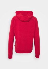 Sudadera roja con bolsillo tipo canguro, capucha y puños acanalados. Fabricada con una suave mezcla de algodón que tiene una textura lisa y un corte casual.