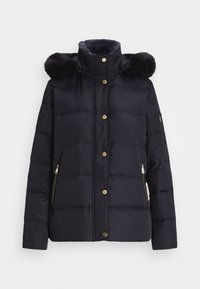 Námořnická puffer bunda s vysokým límcem, umělou kožešinou, zlatými knoflíky a zipovými kapsami. Má prošívaný vzor a měkkou podšívku.