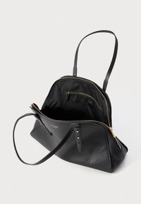 Borsa a tracolla in pelle nera con chiusura a zip, due manici e un ampio interno caratterizzato da una fodera in tessuto e una tasca interna. Accenti dorati visibili.