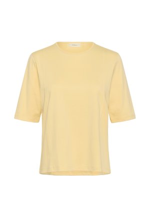 Īsām piedurknēm, gaiši dzeltena T-krekla ar apaļu kakla izgriezumu, brīvs piegriezums un redzamas šuvju detaļas priekšpusē un piedurknēs.