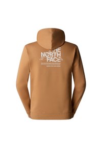 Sweat à capuche marron avec logo blanc The North Face, graphique montagne et texte « Never Stop Exploring » dans le dos.