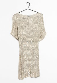 Shimmery gold dress with a loose fit, short sleeves, and a wide neckline. Textured surface covered in sequins. Hangs from a black hook.