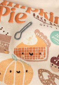 Smiling pumpkin pie slice with whipped cream, a smiling pumpkin, a whisk, and autumn-themed text on fabric background.