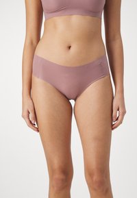 Light mauve seamless underwear with a smooth, elastic waistband and a classic hipster cut, featuring soft fabric and minimalist design.