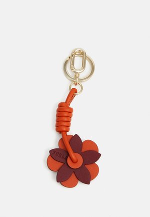 Leather keychain featuring a two-tone flower design in orange and burgundy, with a gold metal ring and twisted orange strap.