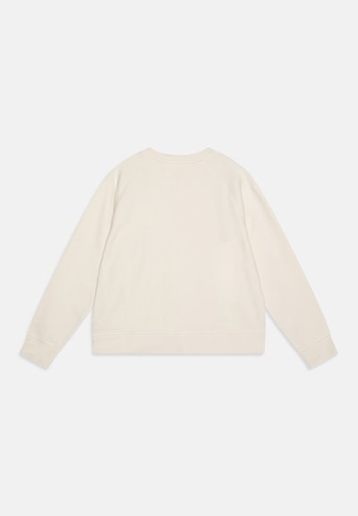 Sudadera de color crema con cuello redondo, mangas largas y puños de canalé. Textura suave con un corte relajado y sin patrones ni diseños visibles.