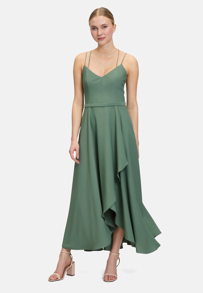 Zielona maxi sukienka z cienkimi ramiączkami, dopasowanym korpusem i asymetrycznym hemem. Wykonana z gładkiego materiału, charakteryzująca się zwiewną sylwetką.