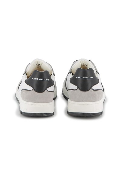 Sneaker grigie e bianche con tomaia in suede e pelle, dotate di un tallone nero con la scritta "MARC JACOBS" in rilievo. Suola in gomma testurizzata.