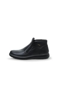 Botín de cuero negro hasta el tobillo con cremallera lateral, punta redondeada y suela texturizada. Presenta un empeine suave con un collar acolchado para mayor comodidad.