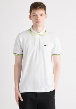 Weißes Poloshirt mit grünem und dunkelblauem gestreiftem Kragen und Ärmeln, mit einem kleinen schwarzen "BOSS"-Logo auf der Brust, aus glattem Baumwollmaterial.