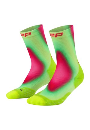 Pair of mid-calf socks with bright green, yellow, and red tie-dye pattern and red lettering on the elastic cuffs.