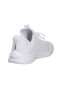 White athletic shoe featuring a textured fabric upper, smooth rubber sole, and soft cushioning with a pull tab and branding on the heel.