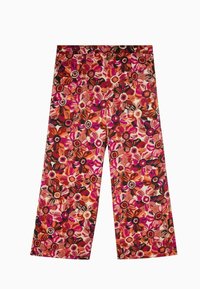 Pantalon à jambes larges à motif floral audacieux avec des fleurs roses, orange et noires sur un fond crème. Confectionné dans un tissu léger.