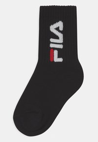 Čierna bavlnená ponožka s rebrovanou textúrou; na boku má pletené biele a červené logo "FILA".
