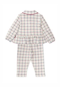 Ensemble de pyjama à carreaux comprenant un haut peplum avec col et passepoil rouge, et un pantalon assorti. Le motif inclut des couleurs bleu, rouge et crème.