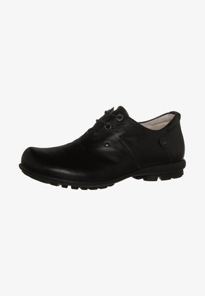 Black leather shoe with a rounded toe, features thin laces, textured upper, and a low rubber sole with small treads for grip.