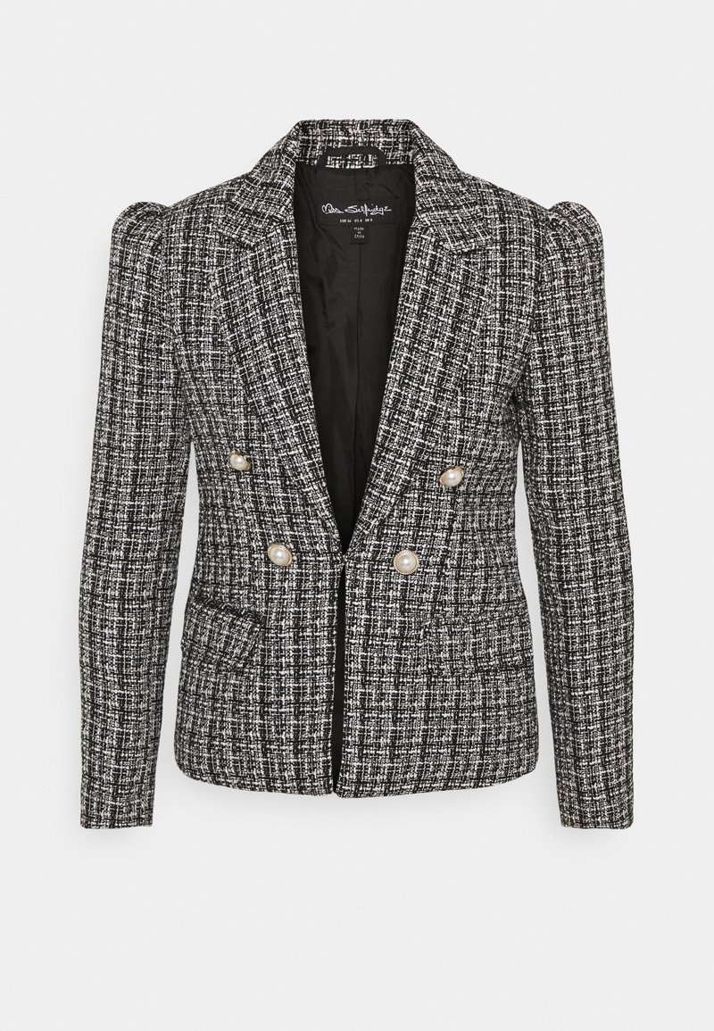 Blazer i sort og hvid tweed, med en tætsiddende pasform, dobbeltknaplukning med perleknapper og strukturerede skuldre. Tekstureret stof.