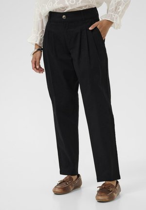 - Spodnie materiałowe