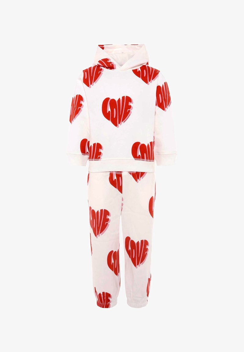 Set di felpa bianca e pantaloni abbinati con grandi cuori rossi e la parola "AMORE". Tessuto morbido, vestibilità rilassata e polsini elastici.