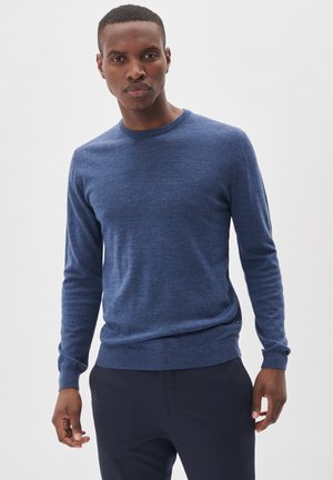 Blue knit sweater with a round neck and long sleeves, featuring a smooth texture and a fitted silhouette. Minimalist design with no patterns.