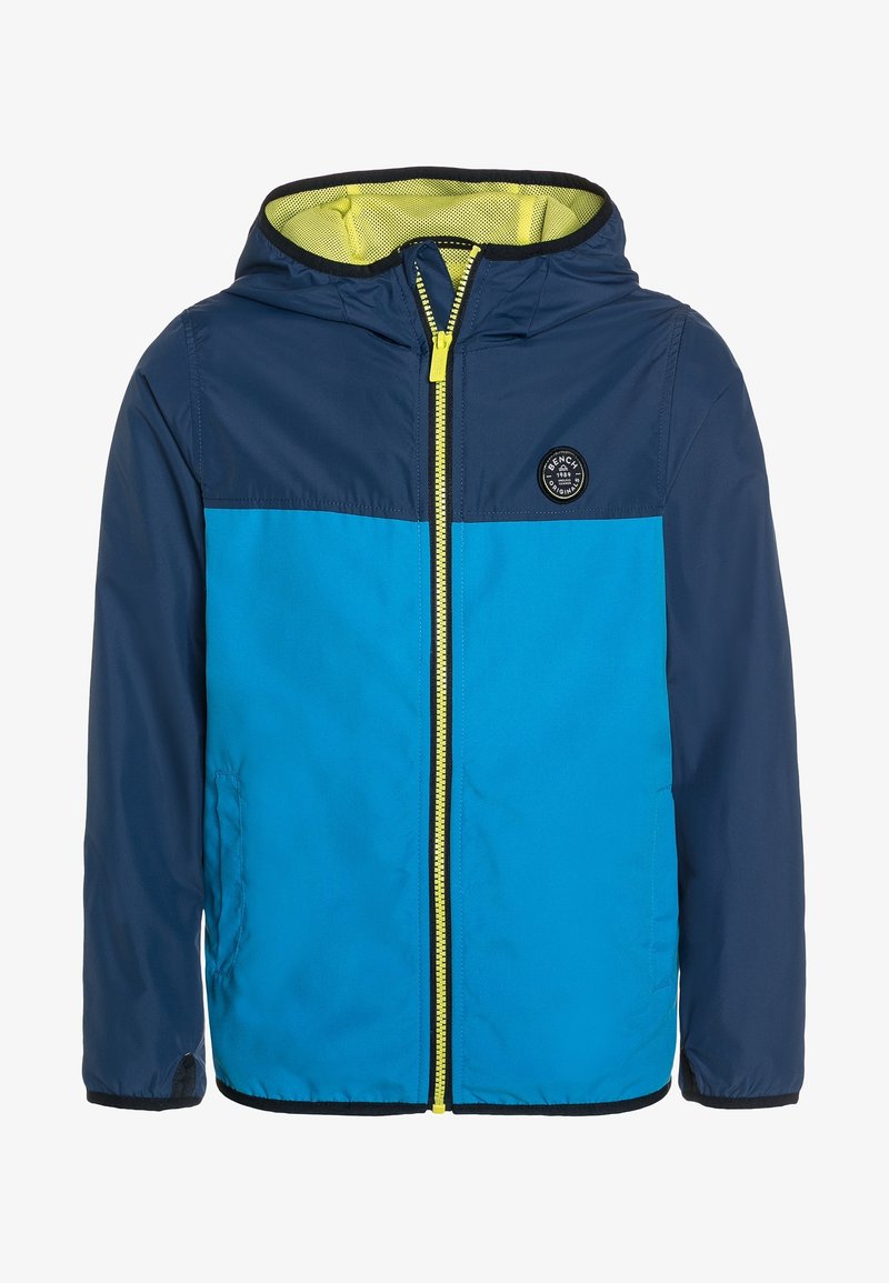 Niebieska i granatowa kurtka z kapturem z zamkiem błyskawicznym z przodu, siateczkowym podbiciem oraz okrągłą naszywką z logo na klatce piersiowej. Zamek błyskawiczny w kontrastującym żółtym kolorze.
