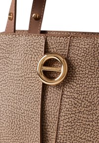 Brown textured leather handbag with a gold circular hardware detail. The finish features a subtle, embossed pattern and stitching accents.