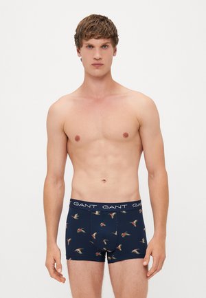 Marineblaue Boxershorts mit einem Blumen- und Vogelmuster; aus weichem Stoff mit einem elastischen Bund, der den Markennamen trägt.