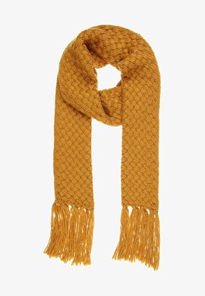 Écharpe tricotée jaune moutarde avec un motif texturé et de longues franges aux deux extrémités, pliée en style boucle.