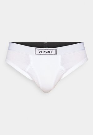 Vita herrunderkläder med svart elastisk midjeband. Tyget verkar slätt och ventilerande, med en kontrasterande logotyp framtill.