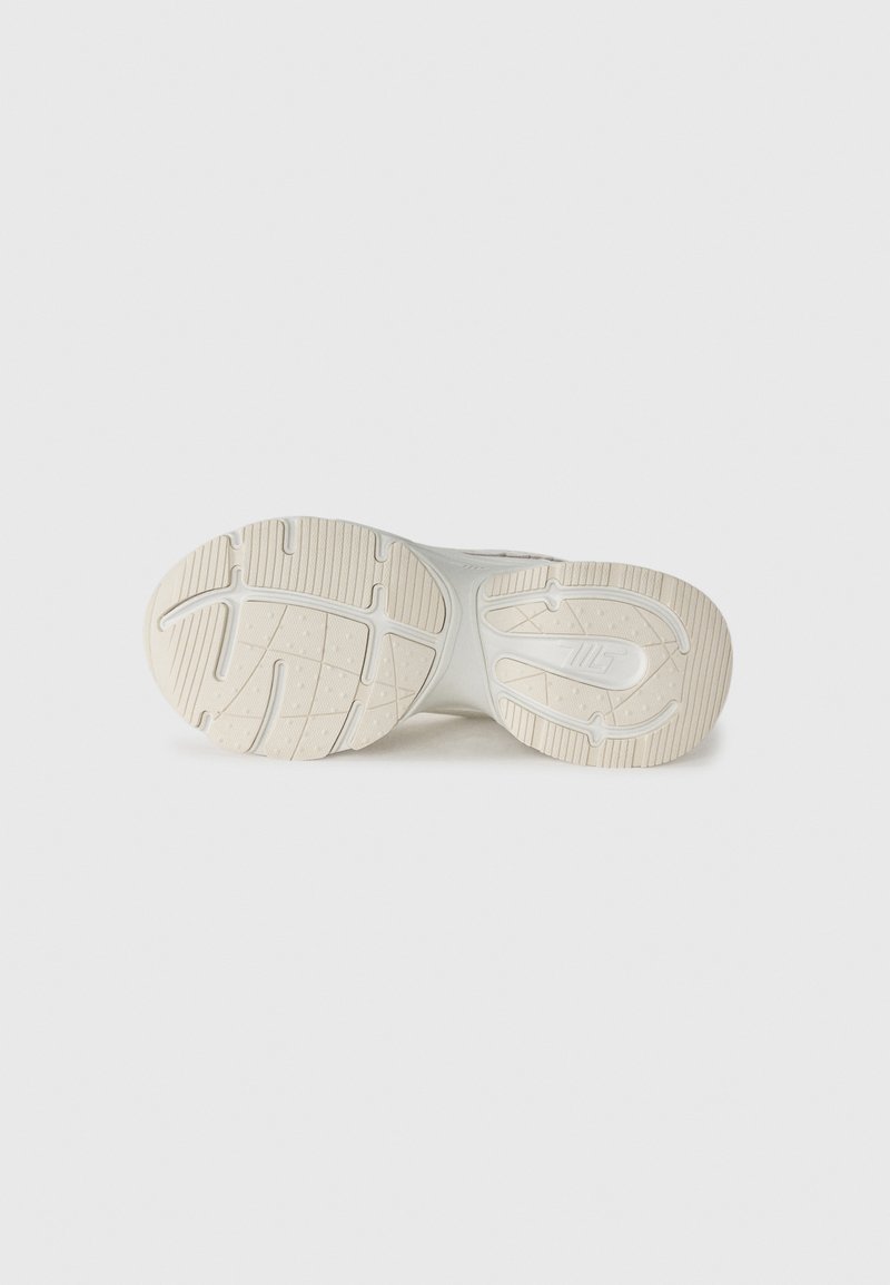 Weiße Sportschuhsohle mit strukturiertem Gummiprofil und einem glatten zentralen Bereich. Bietet gepolsterten Halt und eine geschwungene Form.