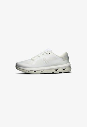 White athletic shoe with a mesh upper, flat laces, padded collar, and a thick white sole featuring cutouts for cushioning and flexibility.