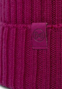 Purple knitted beanie with vertical ribbed texture; features a small, embossed Buff logo on a matching fabric tag.