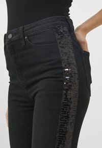 KARL LAGERFELD PANTS - Flared jeans - black solid
