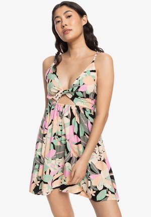 Floral dress featuring a deep V-neck, knotted center, and cutout detail. The fabric displays large pink, green, and orange patterns on a black background.