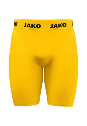 Gelbe enganliegende Shorts mit einem schwarzen elastischen Bund, auf dem der Markenname JAKO wiederholt ist.