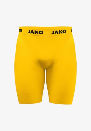 Gelbe enganliegende Shorts mit einem schwarzen elastischen Bund, auf dem der Markenname JAKO wiederholt ist.