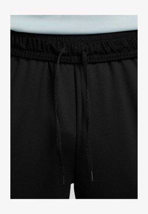 Pantalons de sport noirs avec une taille élastique, dotés d'un cordon de serrage plat et d'une texture de tissu lisse. Aucune motif ni accessoire visible.