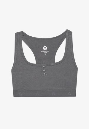 Sports bra grigio attivo caratterizzato da una texture a coste, ritagli sulla schiena, tre dettagli con bottoni sul davanti e un logo stampato sotto il colletto.