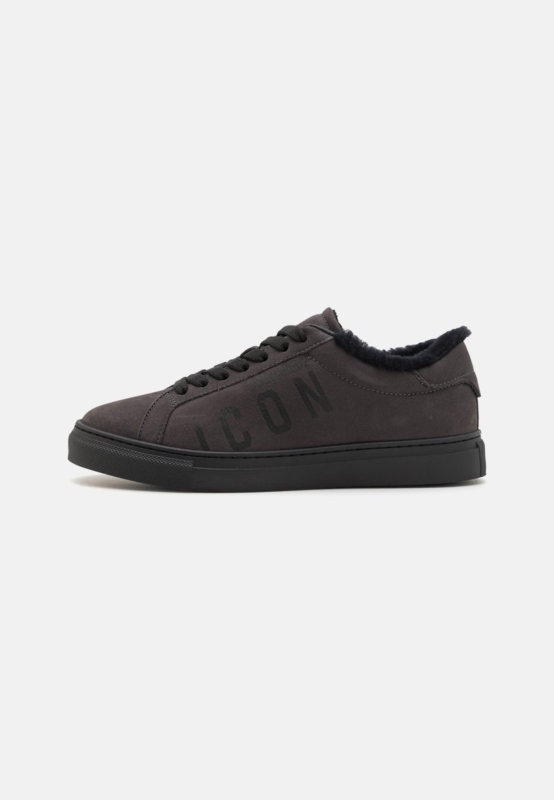 Black suede sneaker with a textured finish, featuring a faux fur collar, flat black laces, and "ICON" lettering on the side. Low-top design.