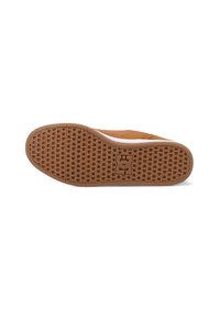 Ruskea kumipohja, jossa on teksturoitu kuvio, keskiössä logo ja valkoinen reunus.