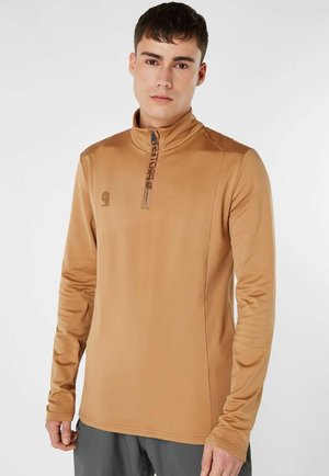 Tan zip-hals pullover gemaakt van gladde, rekbare stof. Kenmerkt lange mouwen, logo-detail en een aansluitend ontwerp.