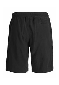 Shorts en tissu texturé noir avec ceinture élastique et une poche arrière unique sur le côté droit, présentés de dos.